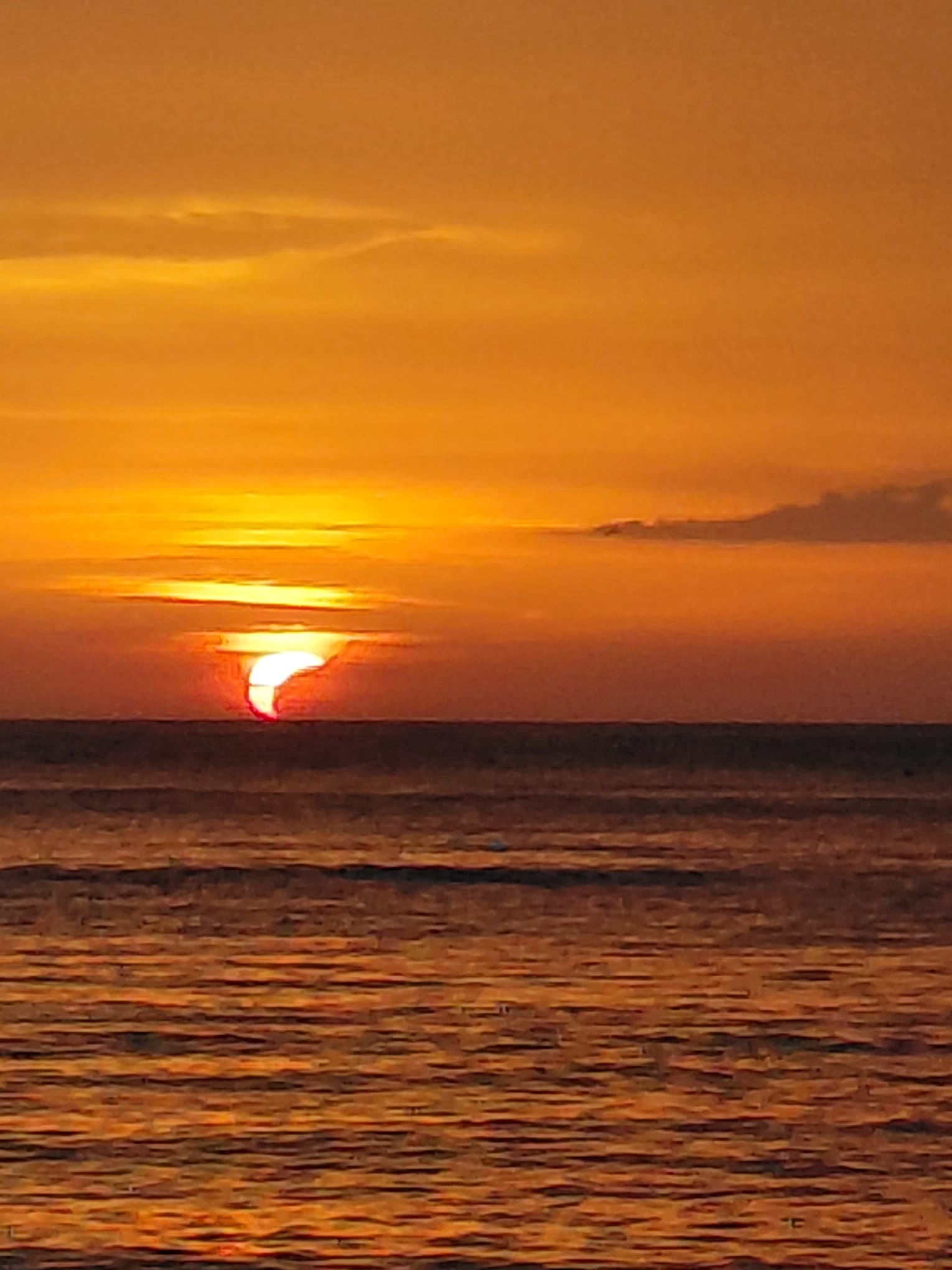 a crescent sun is visible touching the horizon